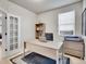 Bright home office with modern desk, sleek shelving, and plenty of natural light for a productive work environment at 7012 S Undergrove Way, Aurora, CO 80016