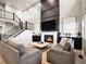 Bright and airy living room with a fireplace, soaring ceilings, and elegant black iron stair railings at 7012 S Undergrove Way, Aurora, CO 80016