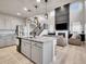 Open-concept kitchen flows into the living room, featuring a kitchen island and soaring ceilings with many windows at 7012 S Undergrove Way, Aurora, CO 80016