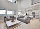 Bright and airy living room offering an open concept layout with views of the kitchen and the outdoor scenery at 7012 S Undergrove Way, Aurora, CO 80016