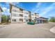 Contemporary condo building featuring ample parking, covered spaces, and a modern architectural design at 1304 Snowberry # 204, Louisville, CO 80027