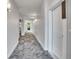 Long hallway with gray patterned carpet and door to unit 202 at 1304 Snowberry # 204, Louisville, CO 80027