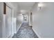 Long hallway with gray patterned carpet and door to unit 201 at 1304 Snowberry # 204, Louisville, CO 80027