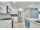 Bright kitchen with stainless steel appliances, white cabinets, and stylish backsplash at 1304 Snowberry # 204, Louisville, CO 80027