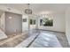 Open-concept living room with wood floors, modern lighting fixtures, and sliding glass doors to a patio at 1304 Snowberry # 204, Louisville, CO 80027