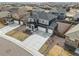 Birds-eye view of a two-story home with a spacious driveway, manicured backyard, and neighborhood at 8374 E 132Nd Pl, Thornton, CO 80602