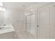 Bright bathroom featuring tiled floors, a double vanity, and a modern glass shower, creating a spa-like retreat at 8374 E 132Nd Pl, Thornton, CO 80602