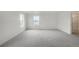 Spacious bedroom featuring plush carpet, ample natural light from two windows, and an ensuite bath at 8374 E 132Nd Pl, Thornton, CO 80602