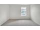 Bright bedroom with neutral carpet and a large window offering comfortable living space at 8374 E 132Nd Pl, Thornton, CO 80602