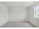 Bright bedroom with two closets, neutral carpet, and a large window, offering ample space at 8374 E 132Nd Pl, Thornton, CO 80602