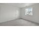 Cozy bedroom with neutral carpet, a large window and a closet door, offering comfortable living space at 8374 E 132Nd Pl, Thornton, CO 80602