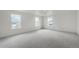 Expansive bonus room filled with natural light through multiple windows, and neutral carpet at 8374 E 132Nd Pl, Thornton, CO 80602