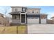 Two-story home featuring a two-car garage, covered front porch, and manicured lawn at 8374 E 132Nd Pl, Thornton, CO 80602