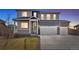 Two-story home featuring a two-car garage, covered front porch, and manicured lawn at 8374 E 132Nd Pl, Thornton, CO 80602