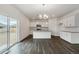 Open kitchen area showing stainless steel appliances, white cabinets, and a sliding glass door to the yard at 8374 E 132Nd Pl, Thornton, CO 80602