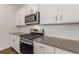 Modern kitchen featuring white cabinets, stainless steel appliances, quartz countertops, and a subway tile backsplash at 8374 E 132Nd Pl, Thornton, CO 80602