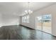 Bright living room with hardwood floors and large glass doors looking out onto the backyard at 8374 E 132Nd Pl, Thornton, CO 80602