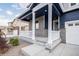Inviting covered porch with white pillars offers a welcoming entry to this charming home at 8374 E 132Nd Pl, Thornton, CO 80602