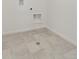 Tiled utility room provides durable flooring and essential hookups, blending functionality with simple design at 8374 E 132Nd Pl, Thornton, CO 80602