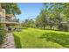 Large backyard features a deck, covered patio, and lush green grass at 5475 W Ottawa Ave, Littleton, CO 80128