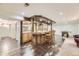 Finished basement features a beautiful wood bar with seating and adjacent recreational area at 5475 W Ottawa Ave, Littleton, CO 80128