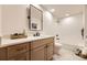 Modern bathroom featuring a wood vanity, a tub, and a clean, minimalist design at 5475 W Ottawa Ave, Littleton, CO 80128