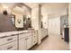 Bathroom with double vanity featuring a large mirror and modern fixtures at 5475 W Ottawa Ave, Littleton, CO 80128