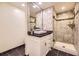 Bathroom showcasing a sink, shower, vanity, and modern fixtures and marble style tiling at 5475 W Ottawa Ave, Littleton, CO 80128