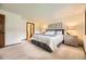 Spacious bedroom featuring plush carpeting, natural lighting and stylish décor at 5475 W Ottawa Ave, Littleton, CO 80128