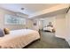 Bright bedroom features carpeted floors, a window, and a comfortable bed at 5475 W Ottawa Ave, Littleton, CO 80128