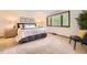 Bright bedroom with a large window, light carpet, and stylish furnishings at 5475 W Ottawa Ave, Littleton, CO 80128