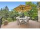 Enjoy outdoor dining on this spacious deck with patio table and umbrella at 5475 W Ottawa Ave, Littleton, CO 80128