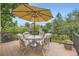 Relaxing outdoor space with patio furniture features a table, chairs, and umbrella at 5475 W Ottawa Ave, Littleton, CO 80128