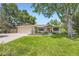 Charming single-story home with a well-manicured lawn and mature trees at 5475 W Ottawa Ave, Littleton, CO 80128
