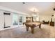 Game room boasts a pool table and access to an outdoor patio through sliding glass doors at 5475 W Ottawa Ave, Littleton, CO 80128