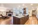 Gourmet kitchen featuring a spacious center island with seating and stone countertops at 5475 W Ottawa Ave, Littleton, CO 80128