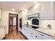 Modern kitchen with white cabinetry, granite countertops, and stainless steel appliances at 5475 W Ottawa Ave, Littleton, CO 80128