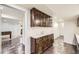 Kitchenette features wooden cabinets, a white countertop, and tiled flooring at 5475 W Ottawa Ave, Littleton, CO 80128