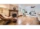 Comfortable living room showcases a brick fireplace, hardwood floors, and natural light at 5475 W Ottawa Ave, Littleton, CO 80128