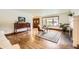 Elegant living room with hardwood floors, fireplace, and a large picture window at 5475 W Ottawa Ave, Littleton, CO 80128