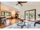 Open living room with fireplace, hardwood floors, and sliding glass doors to outdoor deck at 5475 W Ottawa Ave, Littleton, CO 80128