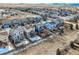 Aerial view highlighting neighborhood with rear fenced yards, trees, and house elevations at 5657 Jaguar Way, Lone Tree, CO 80124