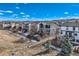 Exterior shot of backyard showing fence line, trees, and partial view of multiple houses at 5657 Jaguar Way, Lone Tree, CO 80124