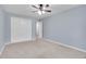 Spacious bedroom with a ceiling fan, carpet flooring, and a double door closet at 710 S Clinton St # 6A, Denver, CO 80247