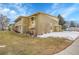 Side view of a multi-unit building featuring grass and mature trees at 710 S Clinton St # 6A, Denver, CO 80247