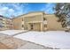 Two-story condo building featuring a well-maintained lawn and snow covered ground at 710 S Clinton St # 6A, Denver, CO 80247