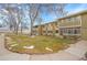 Building featuring well maintained lawn with mature trees and concrete walkways at 710 S Clinton St # 6A, Denver, CO 80247