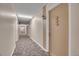 Long hallway featuring neutral walls and patterned carpeting at 710 S Clinton St # 6A, Denver, CO 80247