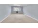 Spacious living room with large window, modern lighting fixture and neutral carpeting at 710 S Clinton St # 6A, Denver, CO 80247