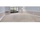 Spacious living room boasts neutral walls, carpeting, and a balcony entrance at 710 S Clinton St # 6A, Denver, CO 80247